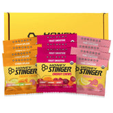 Honey Stinger paquete frontal mostrando variedad de sabores y practicidad para entrenamiento