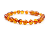 Amber Touch pulsera frontal mostrando cuentas marrones pulidas y diseño unisex