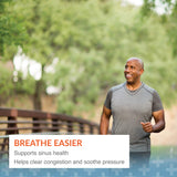 Arthur Andrew Medical cápsula junto a una regla para comparar tamaño y conveniencia