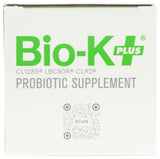 Bio-K Plus comparada con una moneda para ver la escala y portabilidad