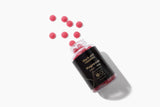 Black Girl Vitamins frasco junto a frutas mixed berry para contexto de sabor