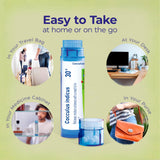 Boiron tubo junto a una mano para comparar tamaño y portabilidad