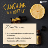 doTERRA frasco de 15 mL junto a moneda para comparar tamaño y facilidad de uso