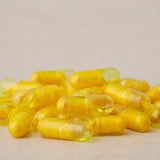 doTERRA cápsula partida mostrando doble cámara, mejora la absorción natural