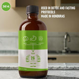 Generic Dr. Sebi Maya Formula frasco junto a una mano para comparar tamaño y porción