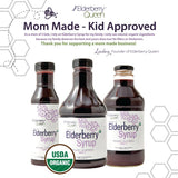 Elderberry Queen botella al lado de frutas para escala, muestra tamaño real