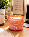 GIFTAWAY envase naranja con hoja plateada que añade toque veraniego y elegante