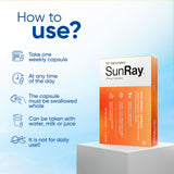Immunotec Sunray cápsula en mano para comparar tamaño y demostrar toma semanal simple
