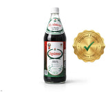 Jigsimur botella 750ml al lado de objetos para escala