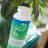 Microbiome Labs FODMATE envase abierto mostrando 120 cápsulas, apoyo puntual