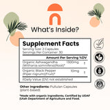 NutriRise cápsulas apiladas destacando forma vegana y fácil ingestión