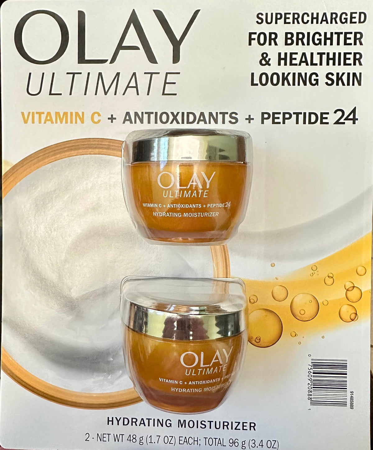 Olay pack frontal mostrando dos frascos para brillo y protección antioxidante
