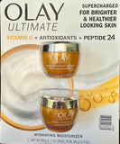 Olay pack frontal mostrando dos frascos para brillo y protección antioxidante