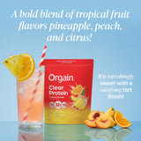 Vaso con Orgain Tropical Punch diluido y aspecto transparente refrescante