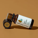 Plant Therapy botella 10 mL junto a monedas y regla para comparar tamaño práctico