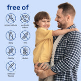 Premom Sperm Fortify cápsulas junto a un vaso para ilustrar toma con comida