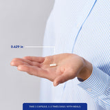 Pure Encapsulations cápsula junto a moneda para referencia de tamaño