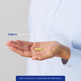 Pure Encapsulations comparación de tamaño de cápsula junto a una moneda para escala