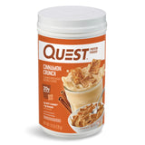 Quest bote frontal con sabor Cinnamon Crunch mostrando diseño y beneficio proteína alta