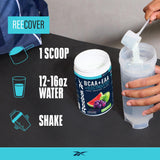 Cuchara medidora junto al envase Reebok REEcover para referencia de porciones