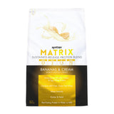 Syntrax Matrix envase frontal 2 lb mostrando etiqueta y sabor Bananas & Cream