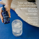 Trace Minerals botella junto a una regla para comparar tamaño y capacidad clara