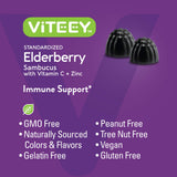Viteey gomitas sobre mesa junto a frutas mostrando combinación nutritiva